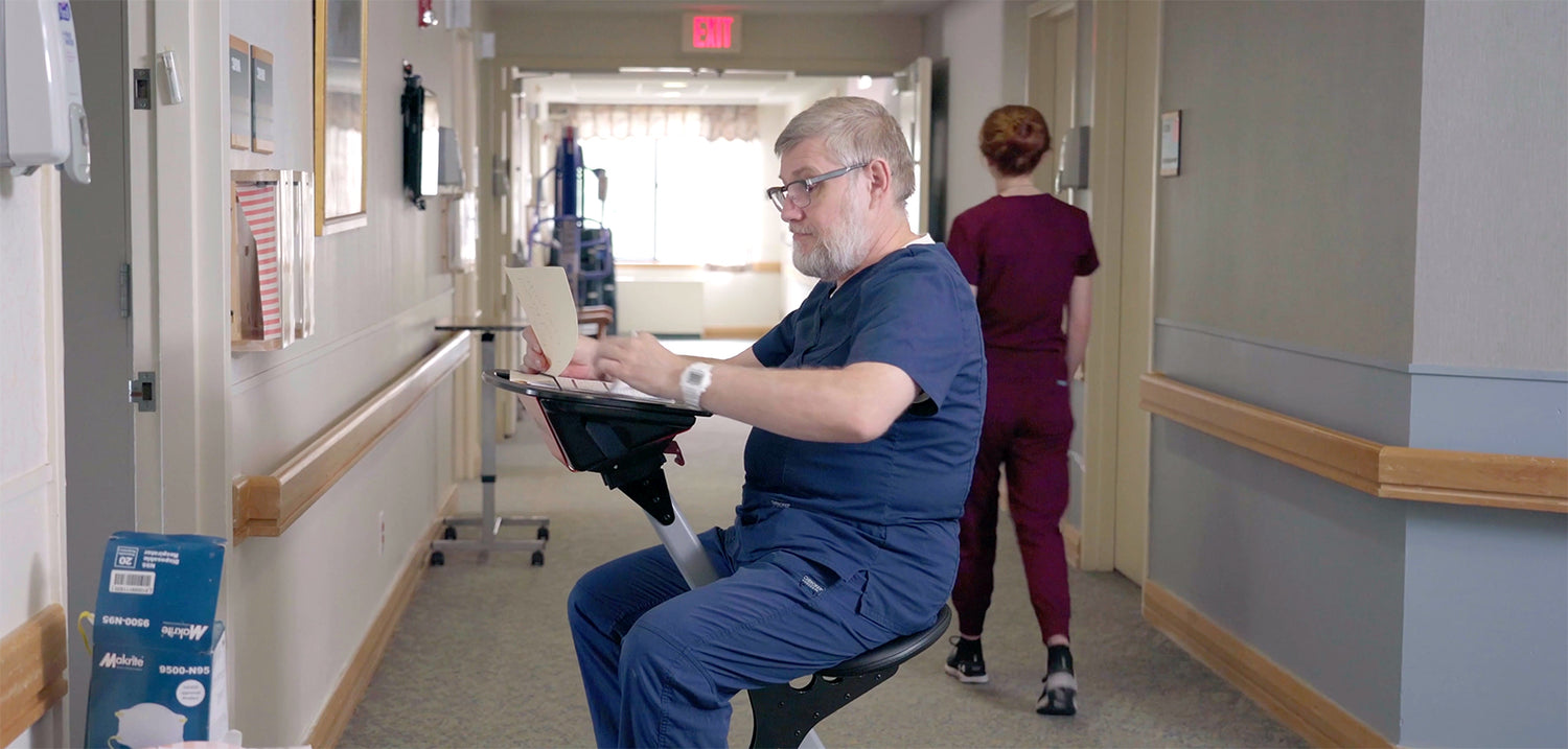 Person seated at a TurboDesk in a clinical workspace